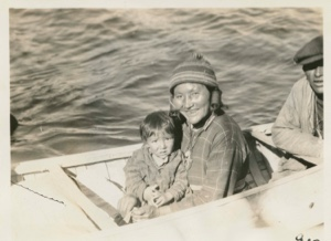 Image of Nascopie Joe's wife, child and a man in canoe by the BOWDOIN [Agathe Rich and son]